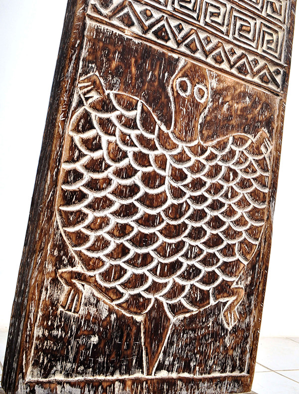 Reclaimed standing wooden decor with carved ethnic pattern