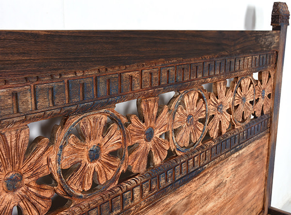 hand-carved wooden bed frame with antique reclaimed finish