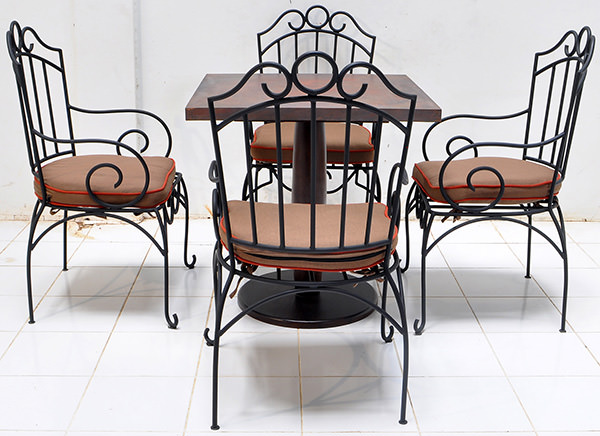 set of hospitality four outdoor iron chair and one copper table