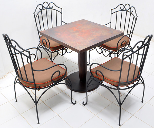 set of hospitality four outdoor iron chair and one square copper table