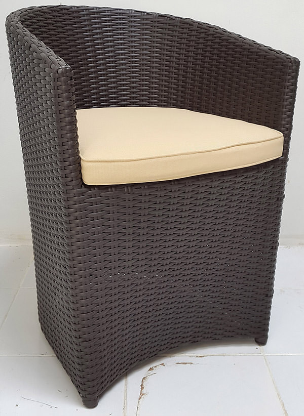 black synthetic rattan armchair with white pillow