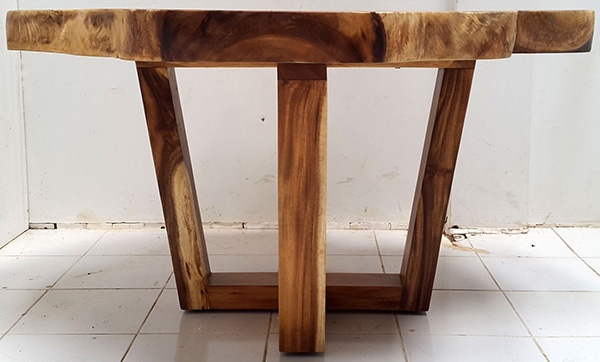 round suar coffee table with natural shape and crossed legs