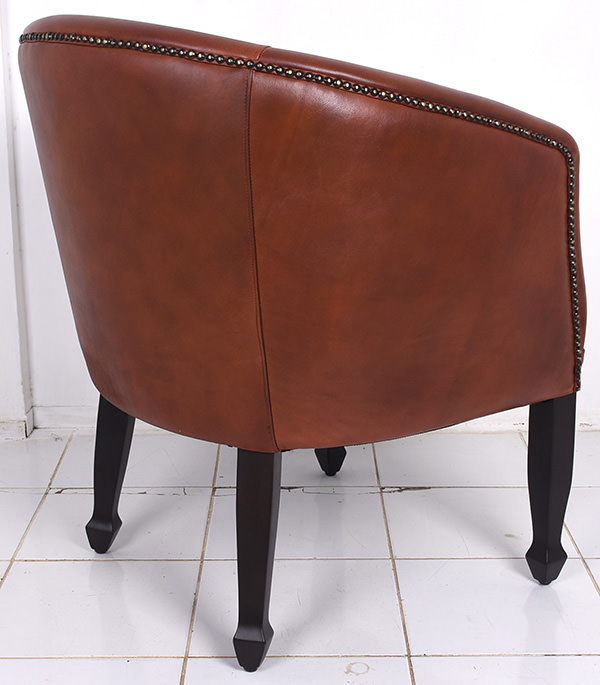 antique leather tub chair with brass pines and mahogany legs