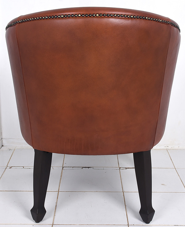 antique leather tub chair with brass pines and bark stain mahogany legs