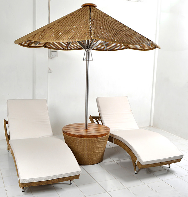 garden umbrella and synthetic rattan lounge chairs