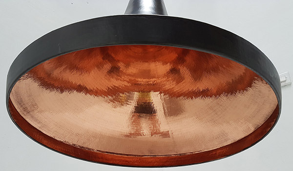 bottom view of black copper lamp with natural red color inside