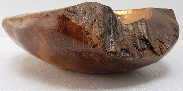 teak bowl with copper insert and a natural shape