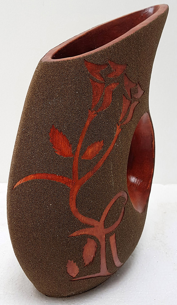 brown and red flower pot with sanded pattern