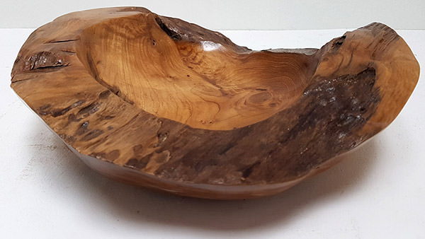 detail of a teak plate with a natural shape