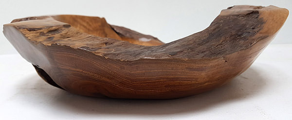 side view of a teak plate with a natural shape