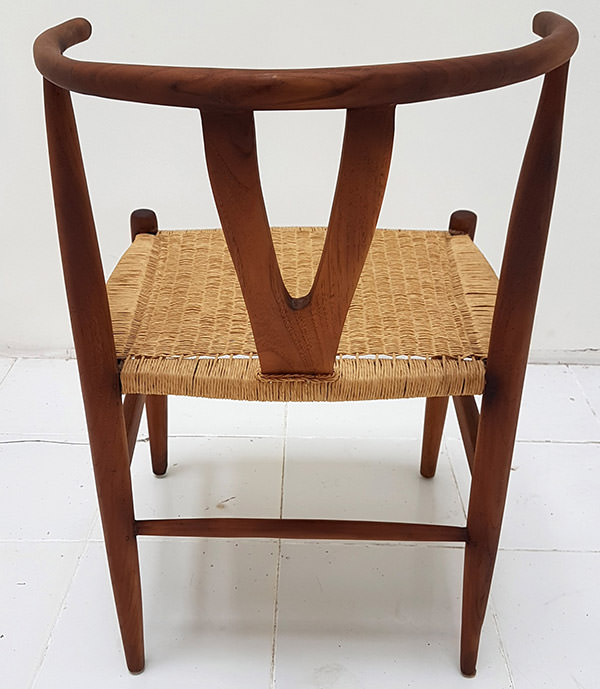 back view of a teak and natural loom scandinavian chair
