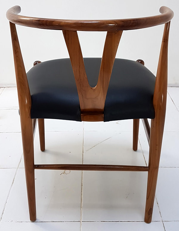 scandinavian dining chair with black leather seat and designed backseat