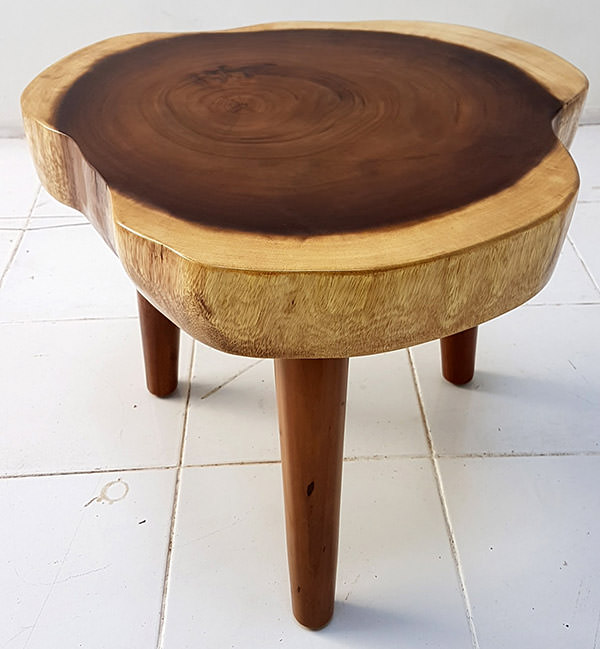 suar coffee table with 3 legs and a natural shape