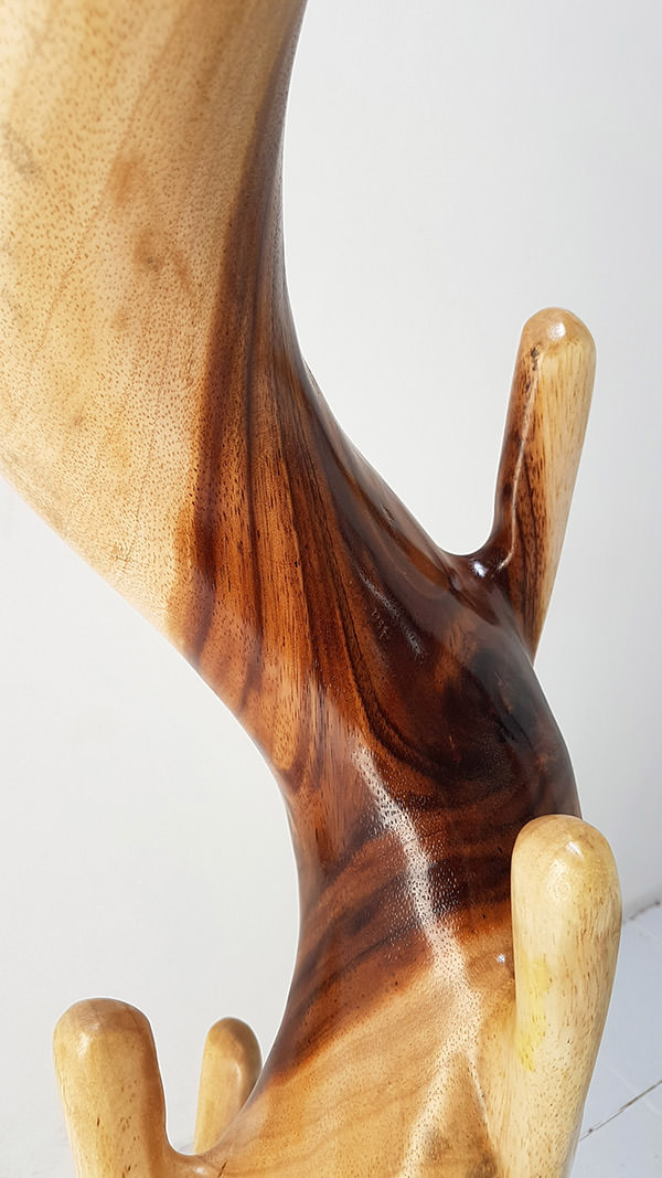 detail of a suar coat hanger with a natural stain