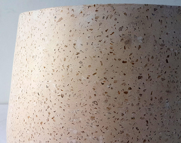 detail of a terrazzo pot with small stones insert
