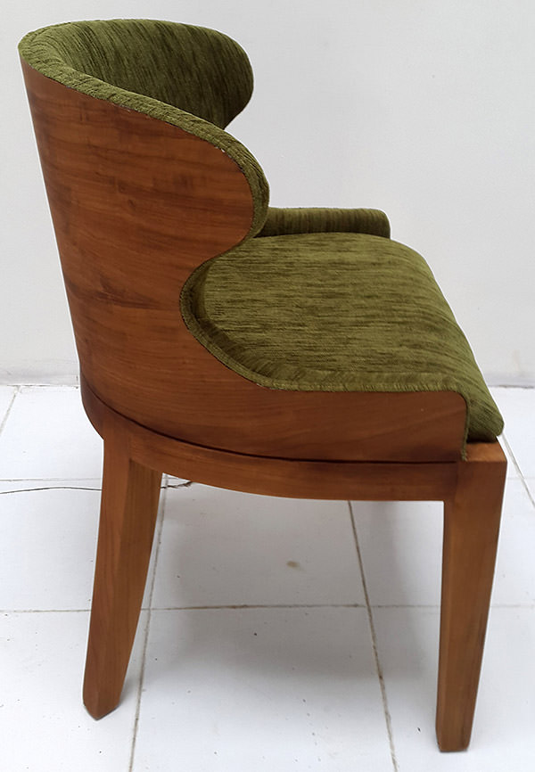 teak armchair with green velvet upholstery and veneer backseat