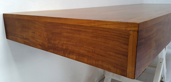 detail of a wall teak desk with brown natural oil finish