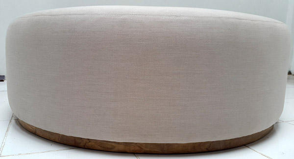 upholstery of a white linen round stool