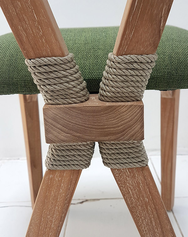 mid-century teak dining chair with ropes around the legs