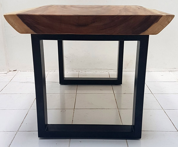Indonesian dining table with suar slab and squared black powder coated iron legs and natural edges