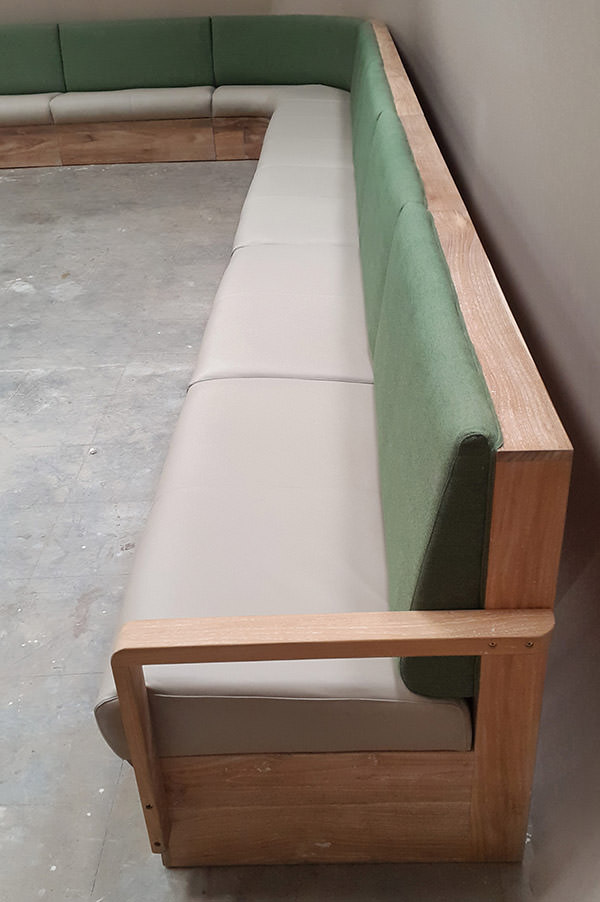 plain linen restaurant banquette with teak wooden frame