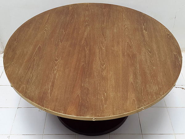 round restaurant table with brass edges and gold washed top