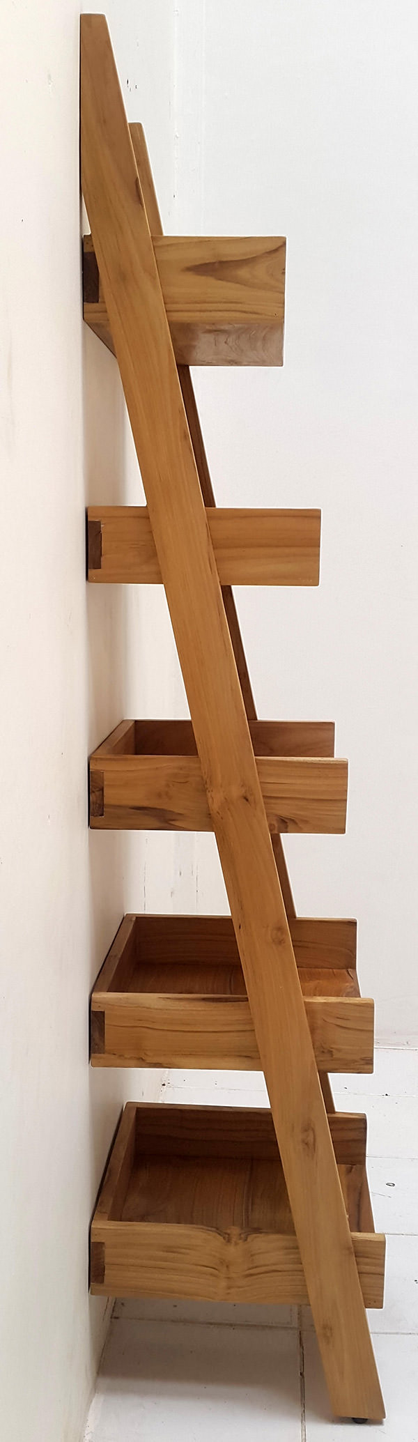 Teak wooden ladder for books against the wall