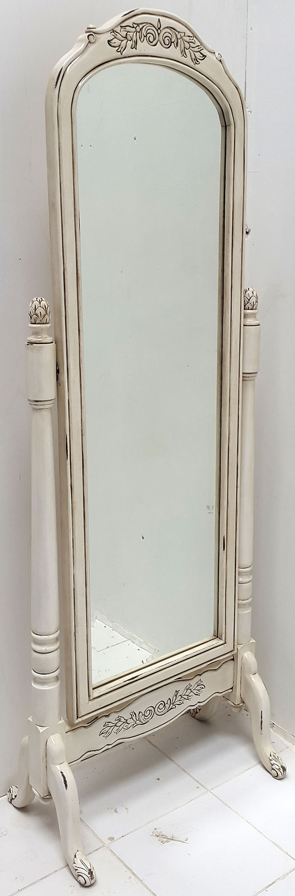 white standing mirror with carved ornements