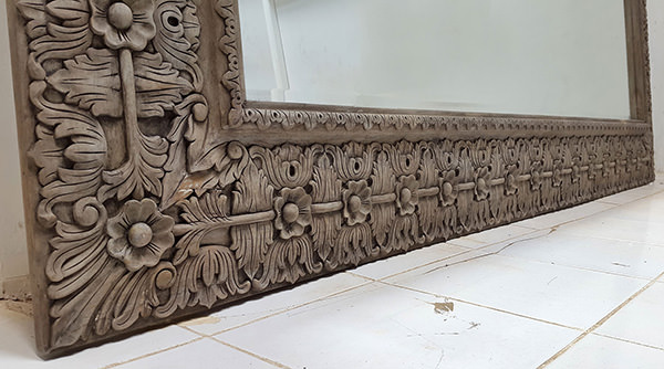 long teak mirror with black stain finish and carved pattern