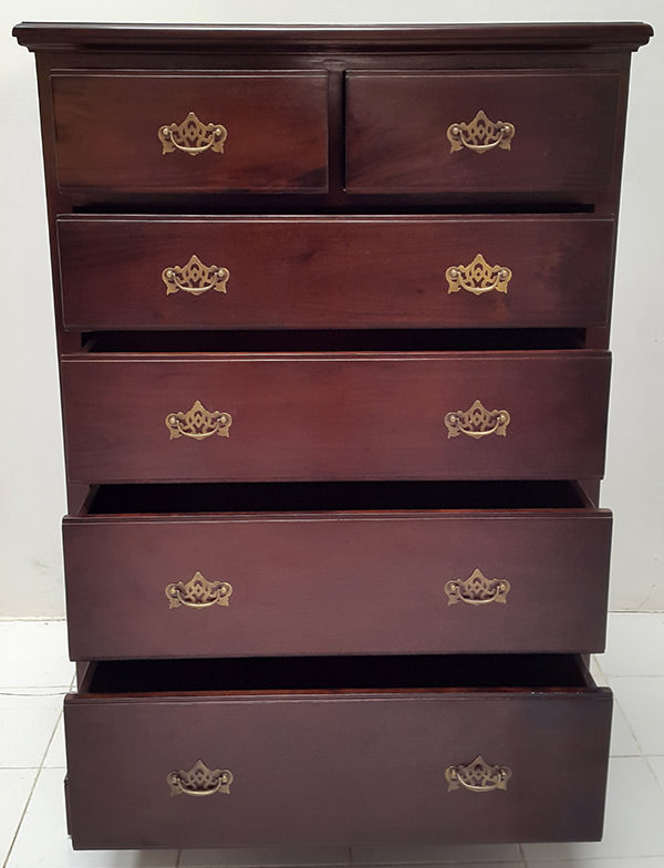 dark brown wooden rack with six drawers and golden handles