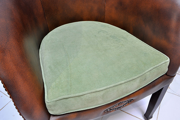 vintage leather restaurant seat with green velvet cushion