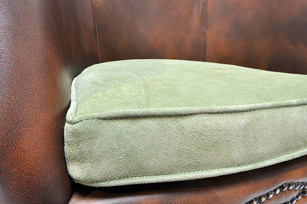 vintage brown leather restaurant seat with green velvet cushion