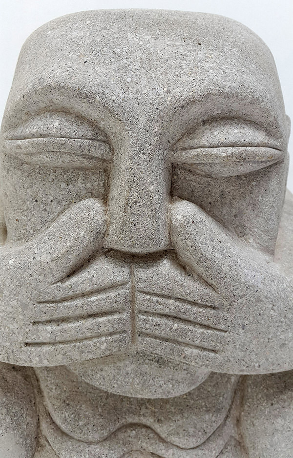 smiling stone sculpture