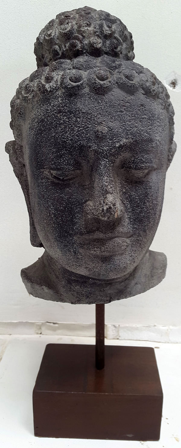 standing black stone sculpture face