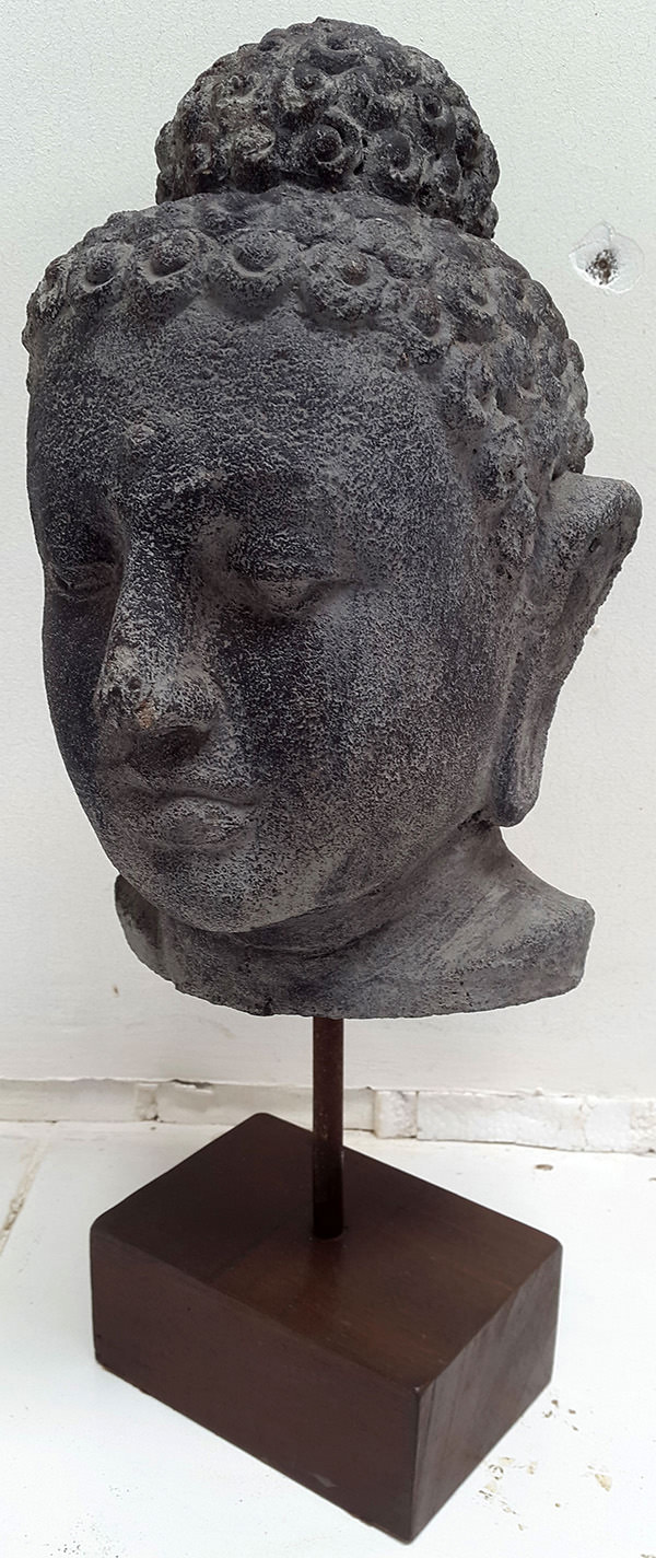 standing black stone sculpture buddha face