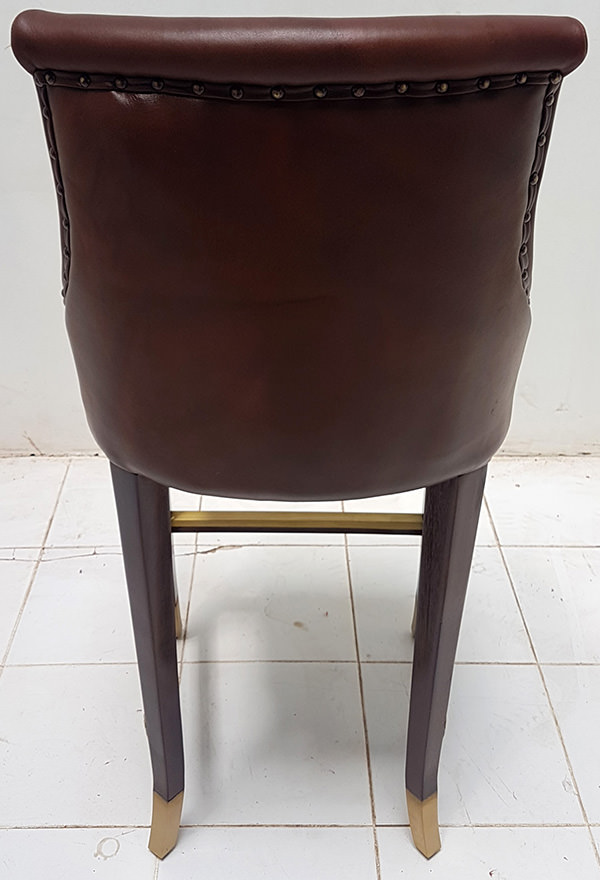 leather dining chair with gold brass foot rest