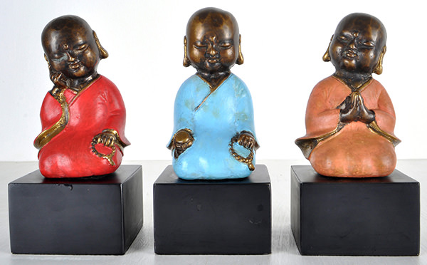 three sitting monks sculpture