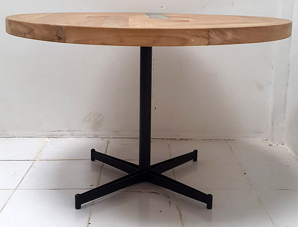 round teak outdoor table with black iron center leg