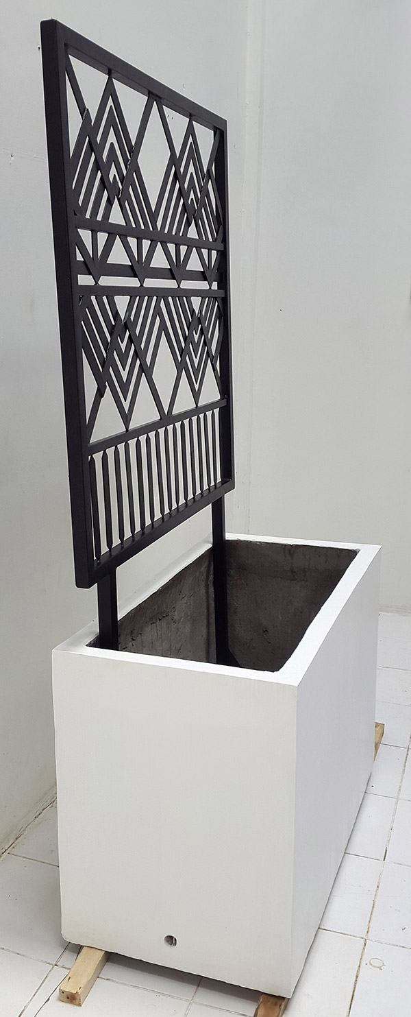 outdoor concrete planter with iron screen panel with geometric pattern