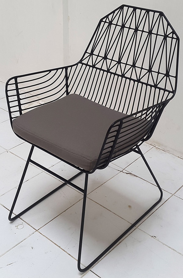 outdoor iron armchair with welded geometric pattern and cushion